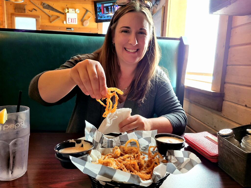 My Town Founder Kristy Burns, eating famous Steak 'n Stein Onion Rings at The Warehouse 